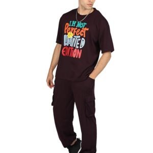 Man wearing maroon graphic t-shirt with cargo pants and black sneakers casual street style