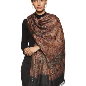 Woman wearing a brown printed woolen shawl with fringe detailing over a white outfit for winter fashion